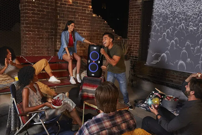 JBL Party speaker sitting on a patio having a karaoke party
