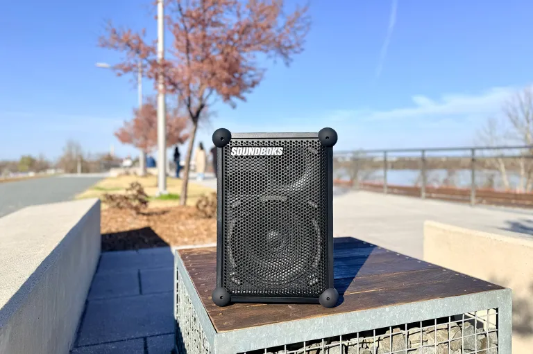 A SOUNDBOKS Mix portable party speaker sitting along the cherry blossom trees on Long Bridge Park, Crystal City, Virginia