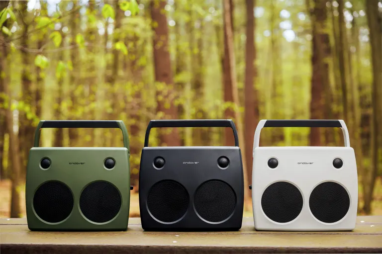 The Andover Sound FreePlay portable stereo Bluetooth speaker shown in Olive, Slate, and Ivory colorways against a woodland background