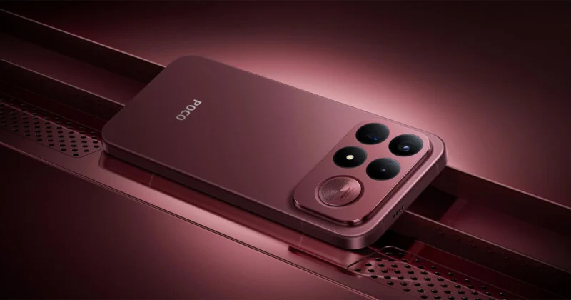 Темно-червоний смартфон з потрійною камерою та круглою решіткою динаміка лежить на відповідній металевій поверхні з перфорованим візерунком.